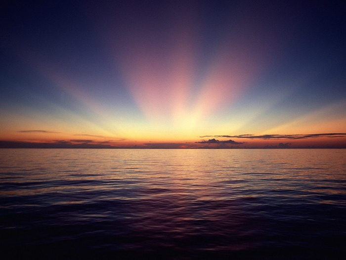 Sunset over the ocean with crepuscular rays