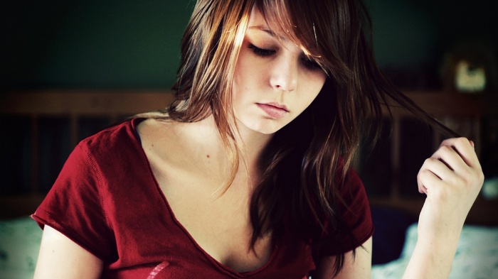 Young woman with brown hair in a red shirt