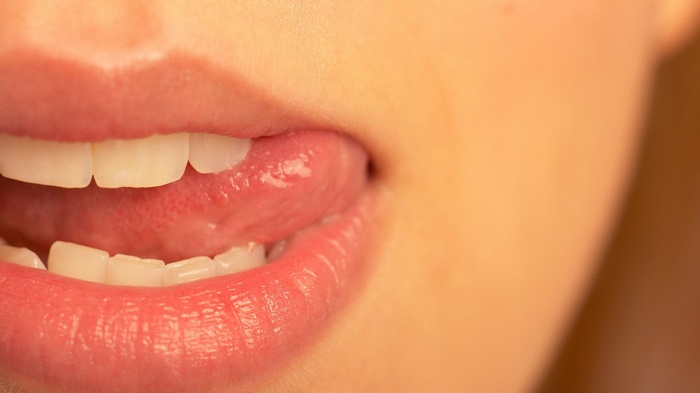 Close-up of a woman licking her lips