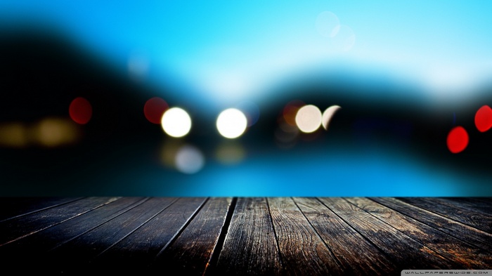 Wooden pier with bokeh lights in the background