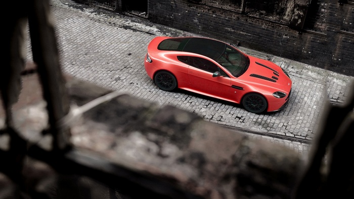 Red Aston Martin Vantage parked on cobblestone street