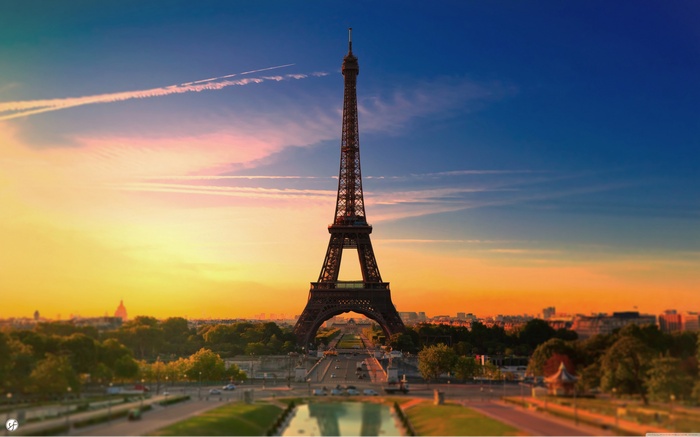 Eiffel Tower at sunset with contrails in Paris
