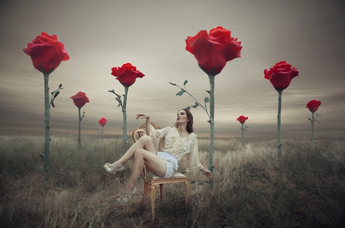 Woman in a field of giant red roses
