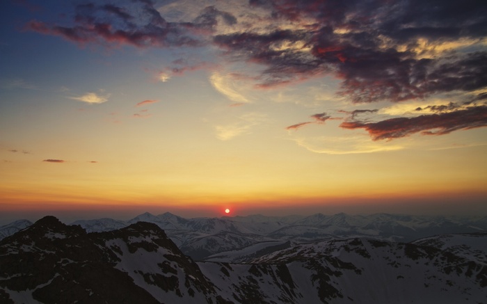 Sunset over snow-capped mountains