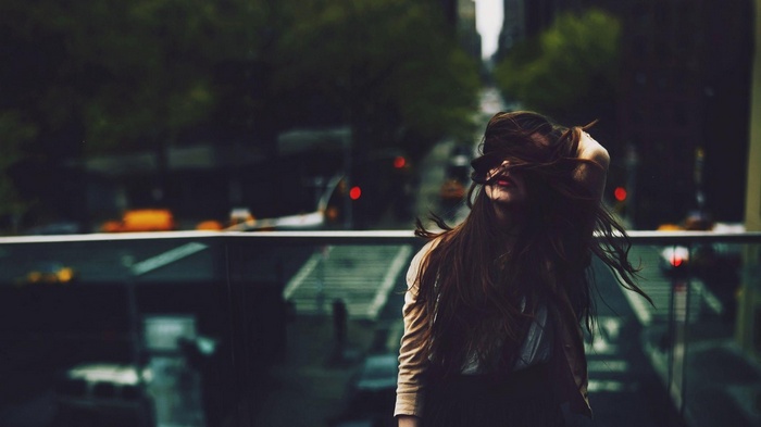 Woman with long hair in a cityscape