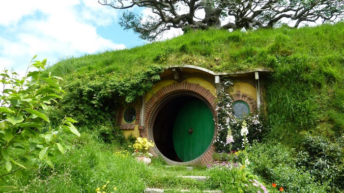 Hobbiton house with green door and grassy hill