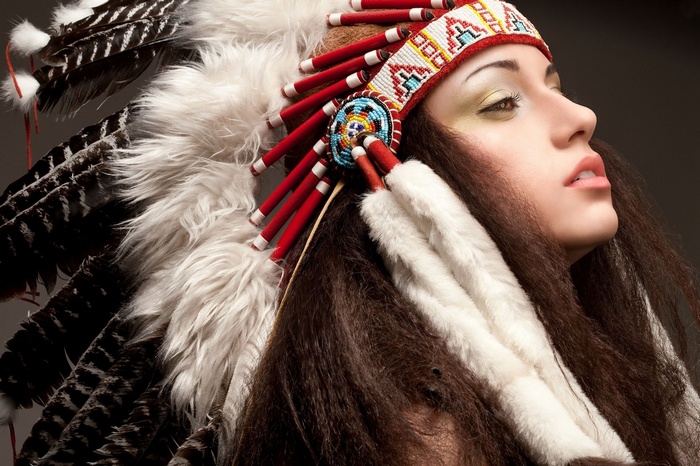 Woman wearing a Native American headdress with feathers