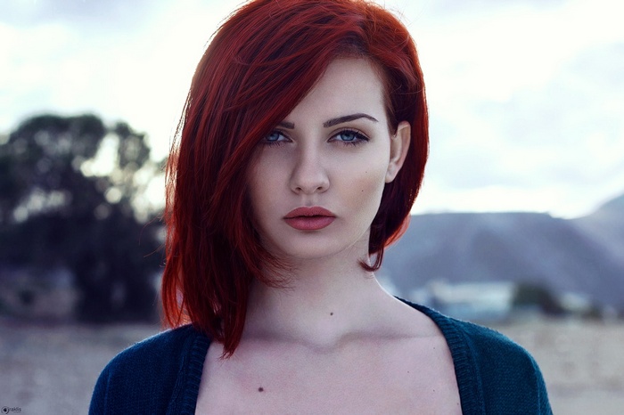 Katerina Roustemi with red hair and blue eyes