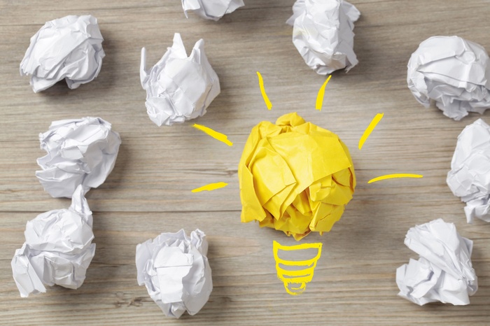 Crumpled paper balls forming a lightbulb idea