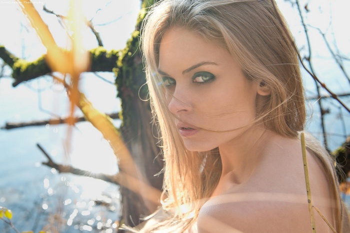 Woman with blonde hair and green eyes outdoors