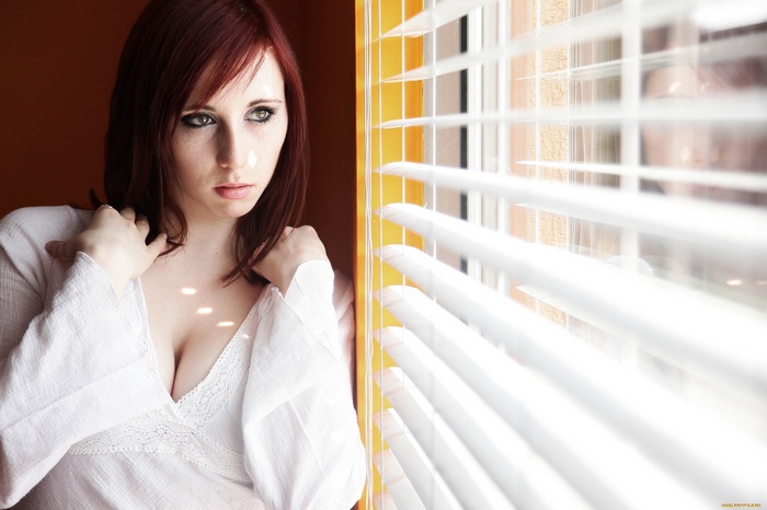 Woman in white top by the window