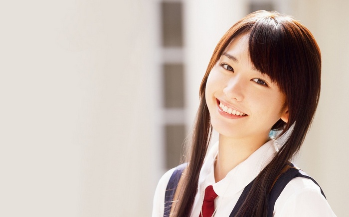 Asian woman smiling with pigtails