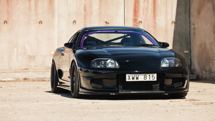 Black Toyota Supra MK4 with purple roll cage