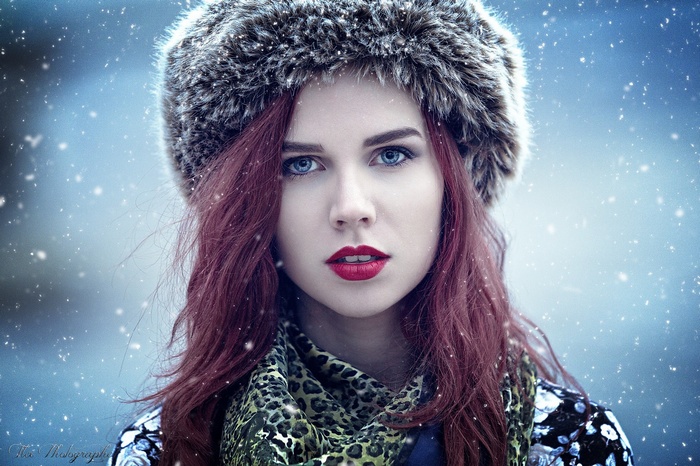 Redhead woman with blue eyes in winter fur hat