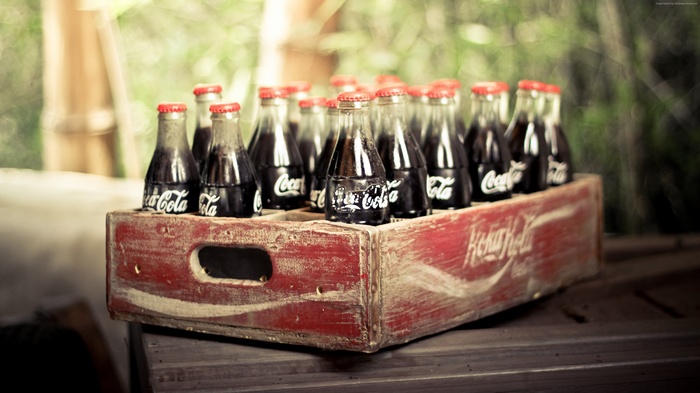 Coca-Cola bottles in a vintage wooden crate