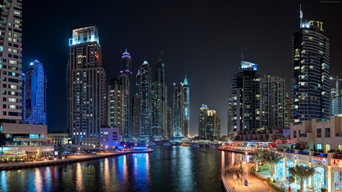 Dubai skyline at night with illuminated skyscrapers and a canal