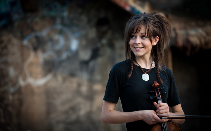 Lindsey Stirling holding a violin