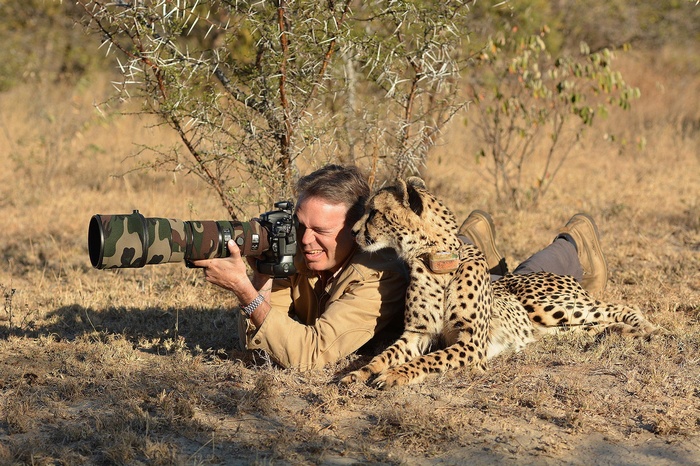 Photographer with Cheetah in Savannah