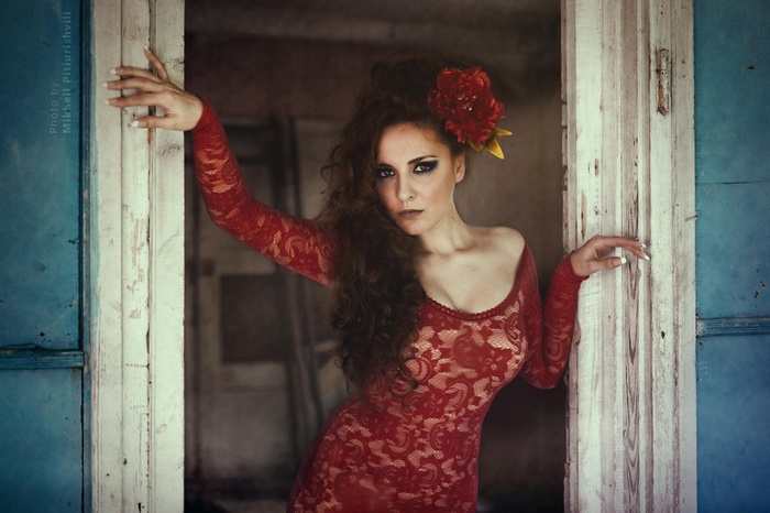 Woman in red lace dress with flower in hair