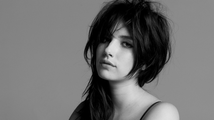 Emma Roberts with dark, messy hair