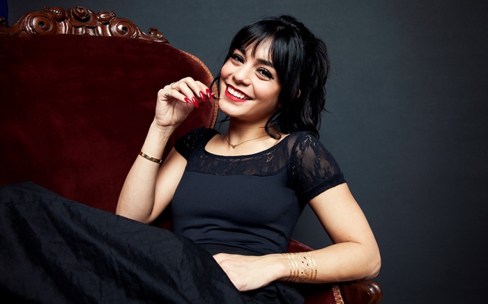 Vanessa Hudgens sitting in a red chair