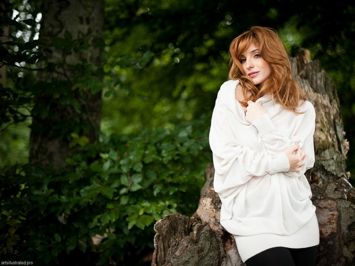 Vica Kerekes with freckles and red hair in a sweater