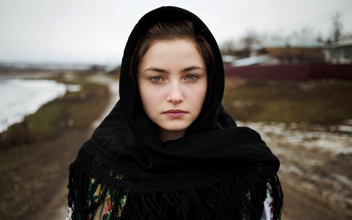 Young woman with green eyes wearing a black scarf