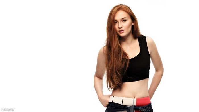 Sophie Turner in a black crop top and jeans