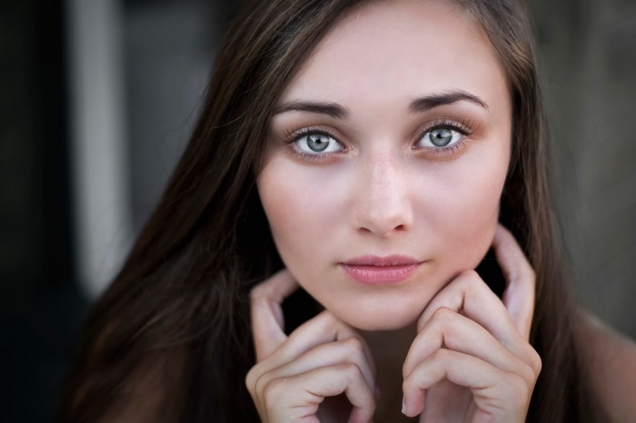 Close-up portrait of a young woman with blue eyes