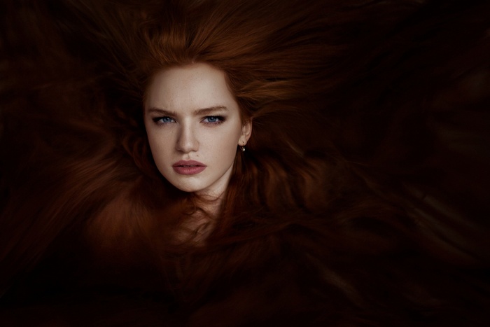 Redhead woman with blue eyes and long hair