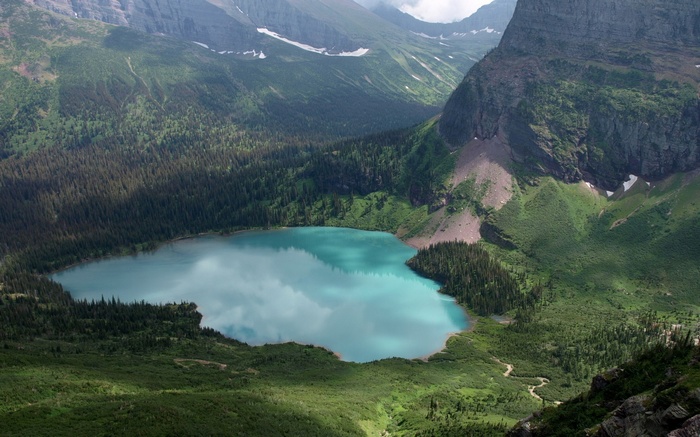 Turquoise Lake Surrounded by Mountains and Forests in Montana