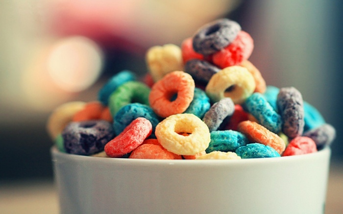 Bowl of colorful fruit loop cereal with bokeh background