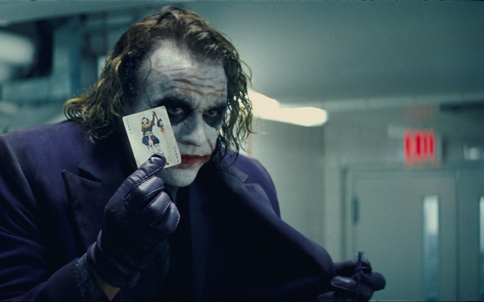 The Joker holding a playing card