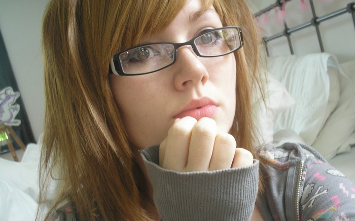 Woman with auburn hair and glasses