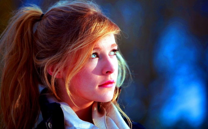 Woman with blonde hair looking up