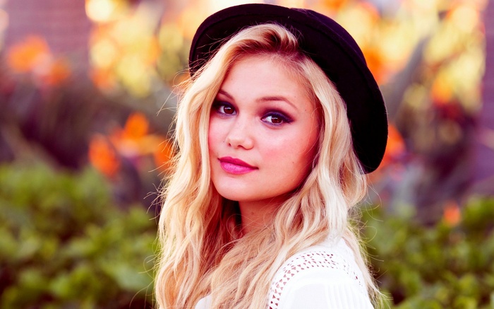 Olivia Holt wearing a black hat