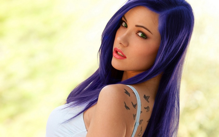 Elizabeth Marxs with violet dyed hair and bird tattoo