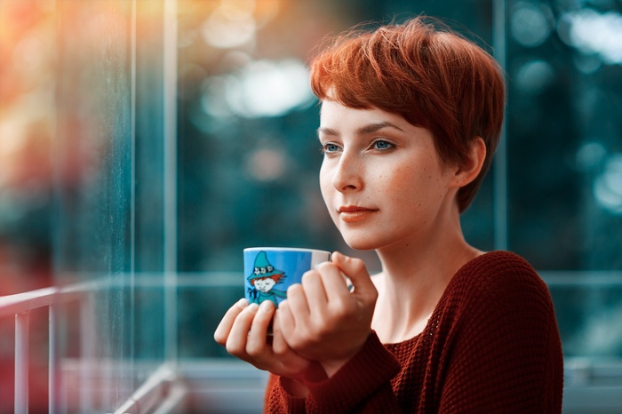 Woman with red hair holding a mug
