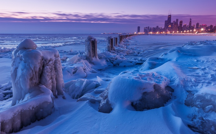 Chicago skyline over frozen Lake Michigan at dusk