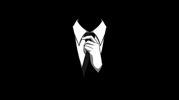 Anonymous figure adjusting tie in a suit