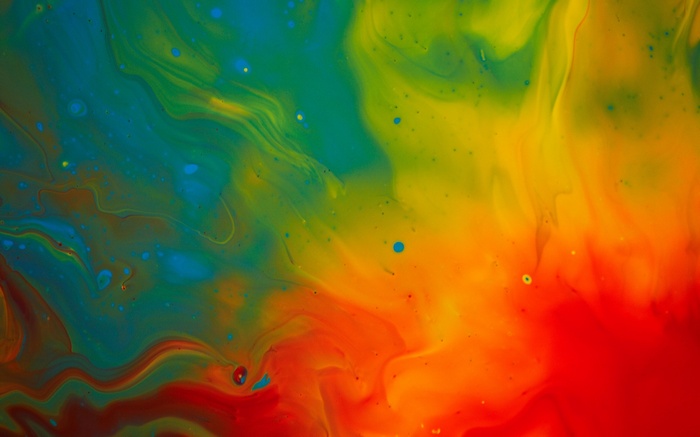Abstract watercolor paint swirls of green, yellow, and red