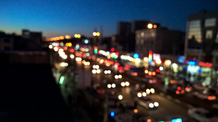 Bokeh lights of traffic on a city street at dusk