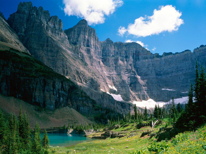 Majestic mountains overlooking a turquoise lake in Glacier National Park