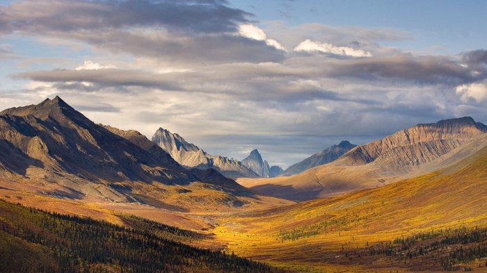 Autumn mountain valley landscape with dramatic clouds