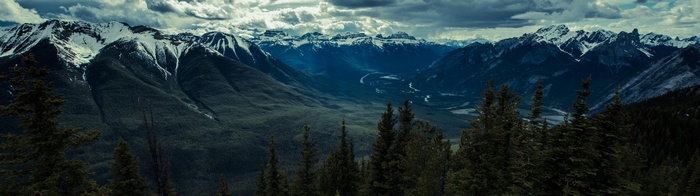Panoramic view of snow-capped mountains and a valley