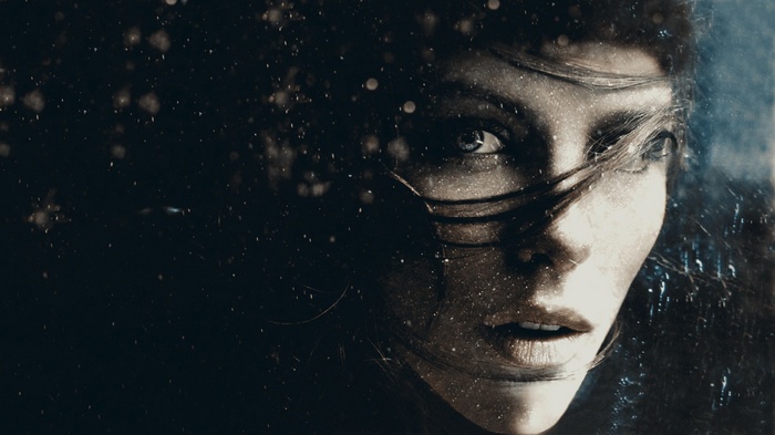 Woman's face with hair blowing in the wind