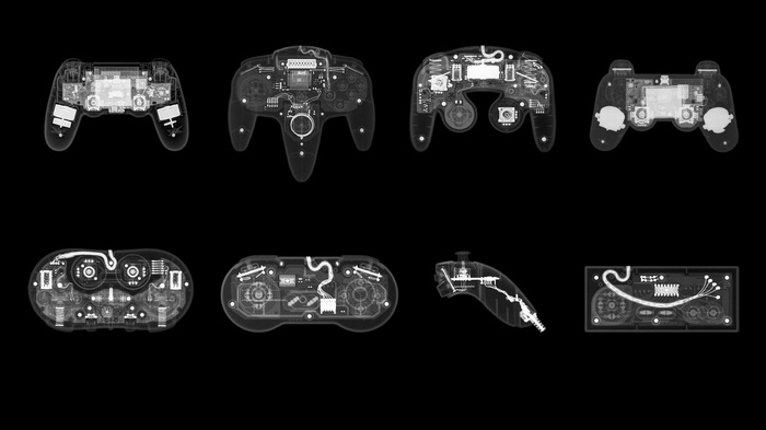 X-rays of various video game controllers on a black background