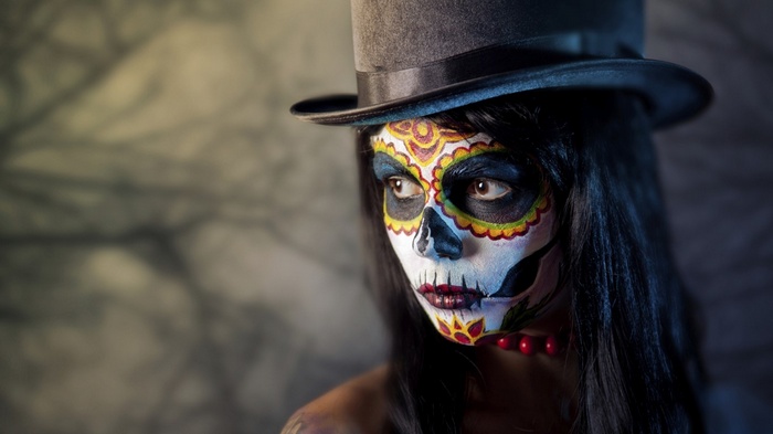 Woman with Day of the Dead makeup and top hat