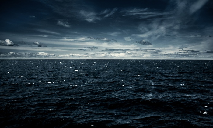 Dark sea under a cloudy sky