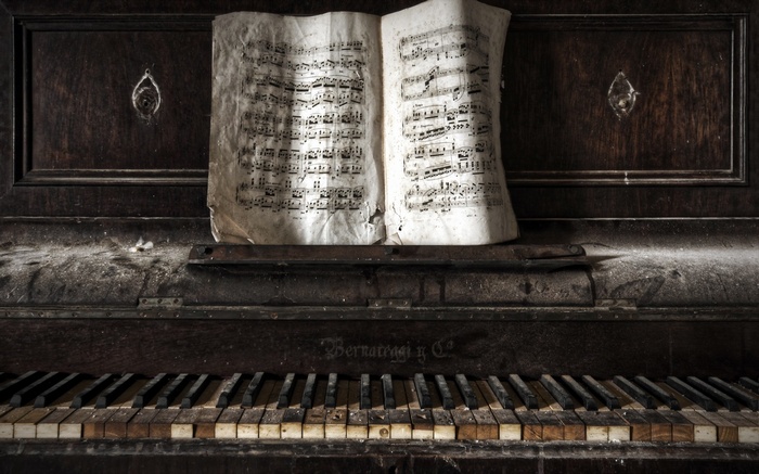 Abandoned piano with old sheet music
